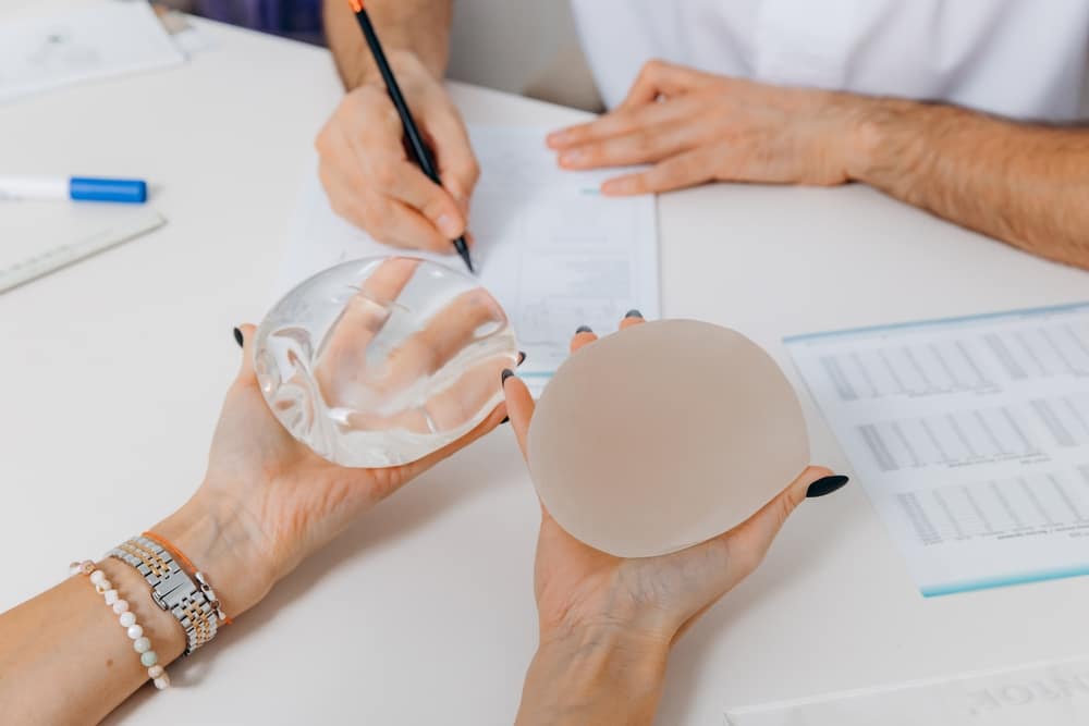 Woman choosing between saline vs. silicone implants in Westlake, OH