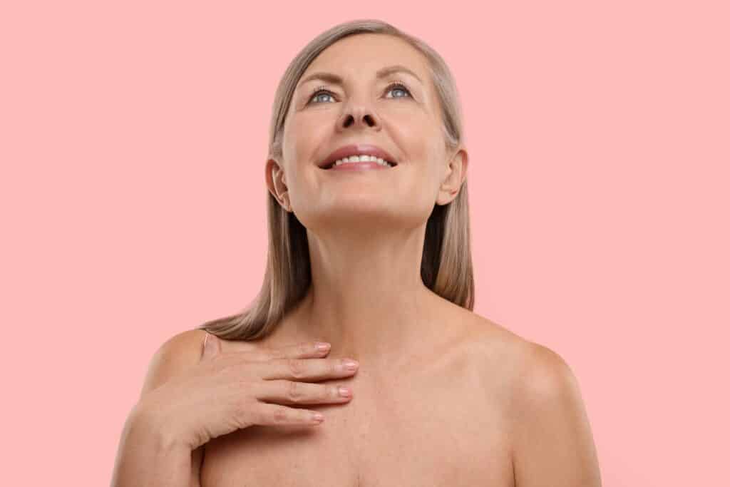 A woman lifting her chin showing the results of a neck lift in Cleveland